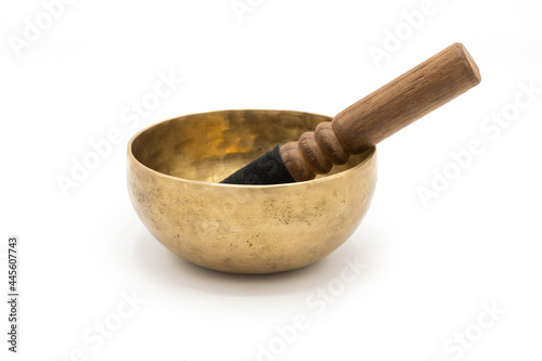 Handmade Tibetan singing bowl with a stick, isolated on a White background