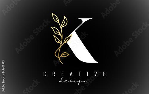 White K letter logo design with golden leaves branch vector illustration. photo