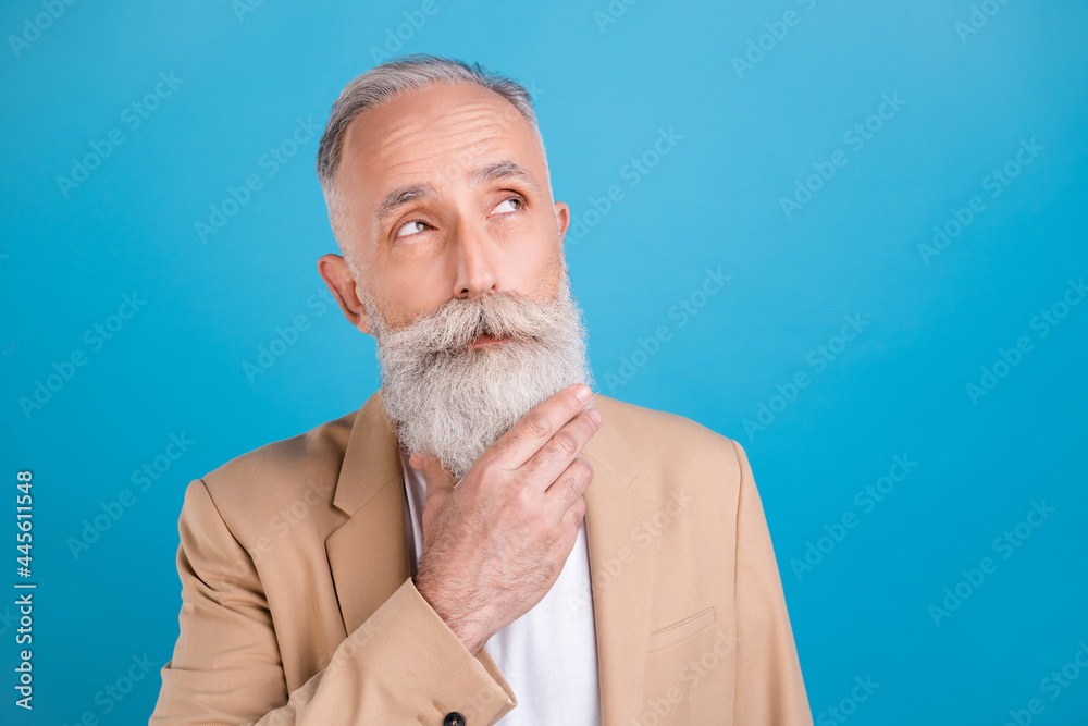 Portrait of handsome minded smart clever grey-haired man overthinking copy space isolated over bright blue color background Portrait of handsome minded smart clever grey-haired man overthinking copy space isolated over bright blue color background