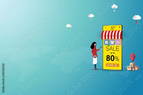 Concept of online shopping, young woman is standing in front of a big smartphone that the display contain list of products and discount rate to order a new pant in green color background.