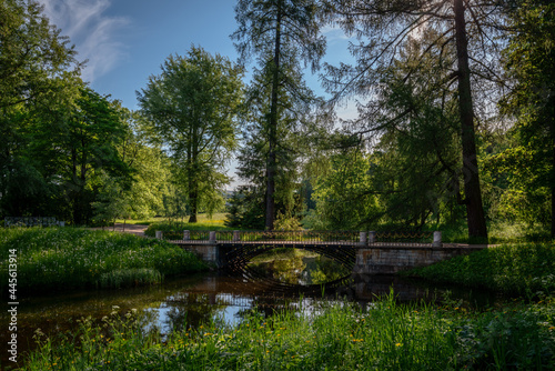 The bridge over the Upper Ponds to the kitchen ruins in Catherine Park in Tsarskoye Selo on a sunny summer evening. Pushkin, St. Petersburg. Russia.