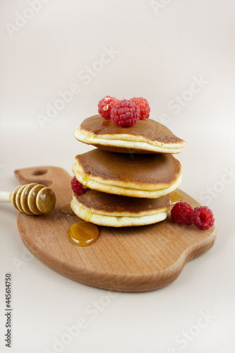 A stack of delicious homemade pancakes with raspberries