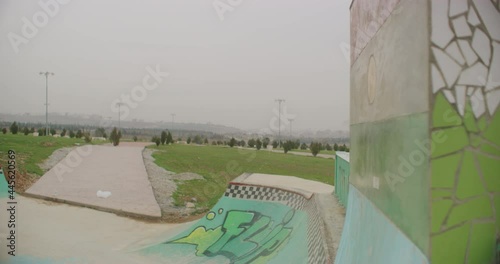 Skateboarders Carve A Quarter Pipe At The Suli Skate Park in Sulaymaniyah, Iraq photo