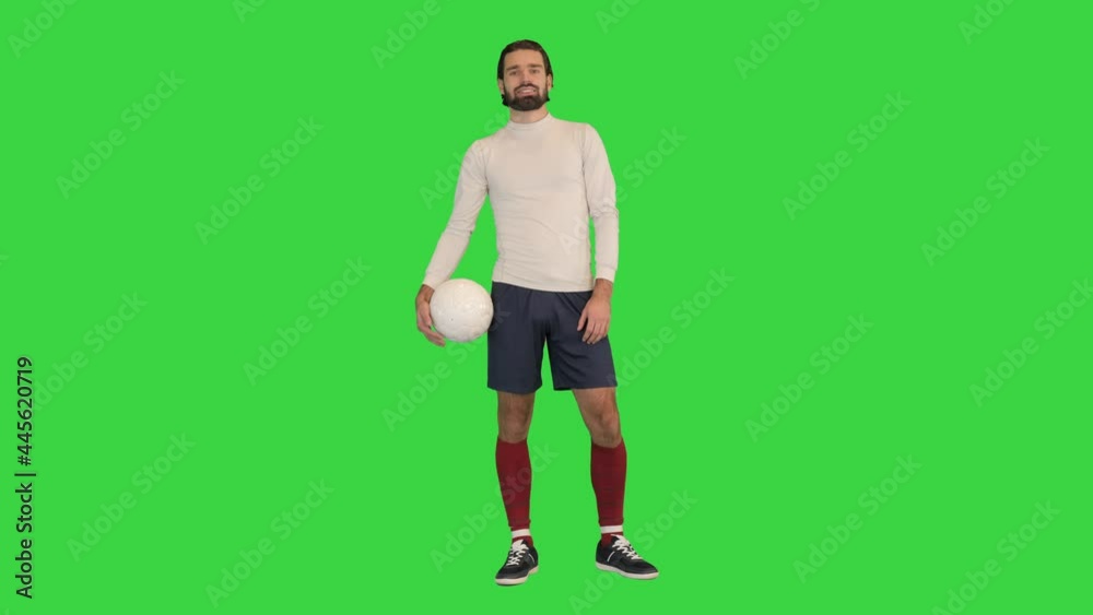 Young soccer player with a ball on a Green Screen, Chroma Key. Young soccer player with a ball on a Green Screen, Chroma Key.