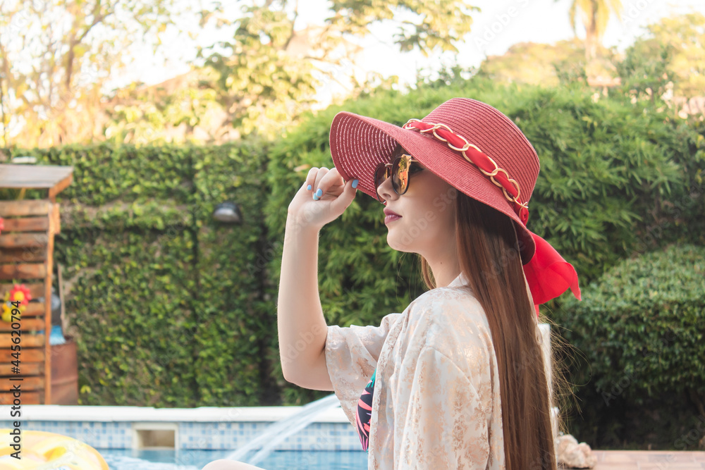 Portrait of a beautiful young girl with red hat and sunglasses.