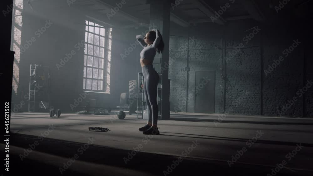 Sportswoman warming neck muscles for training. Woman getting ready for workout Sportswoman warming neck muscles for training. Woman getting ready for workout