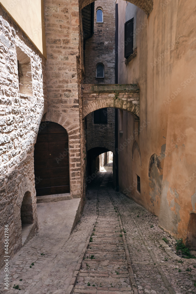 alley with arches in the medieval town of spello umbria