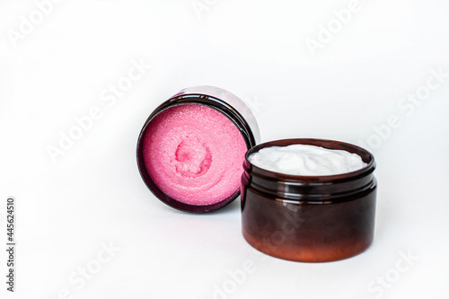 pink body scrub and body cream in brown jars