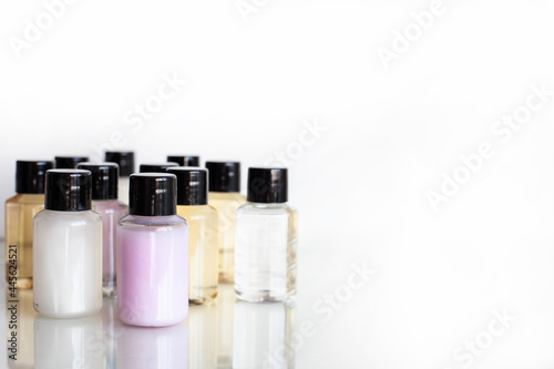 many multi-colored bottles with body and hair care products.