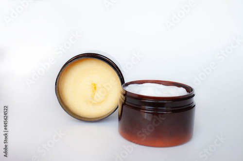 yellow body scrub and body cream in brown jars