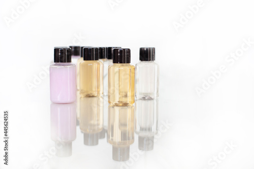 many multi-colored bottles with body and hair care products. with reflection