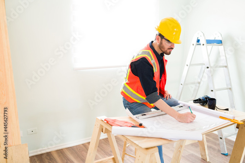 Contractor working on the construction plans