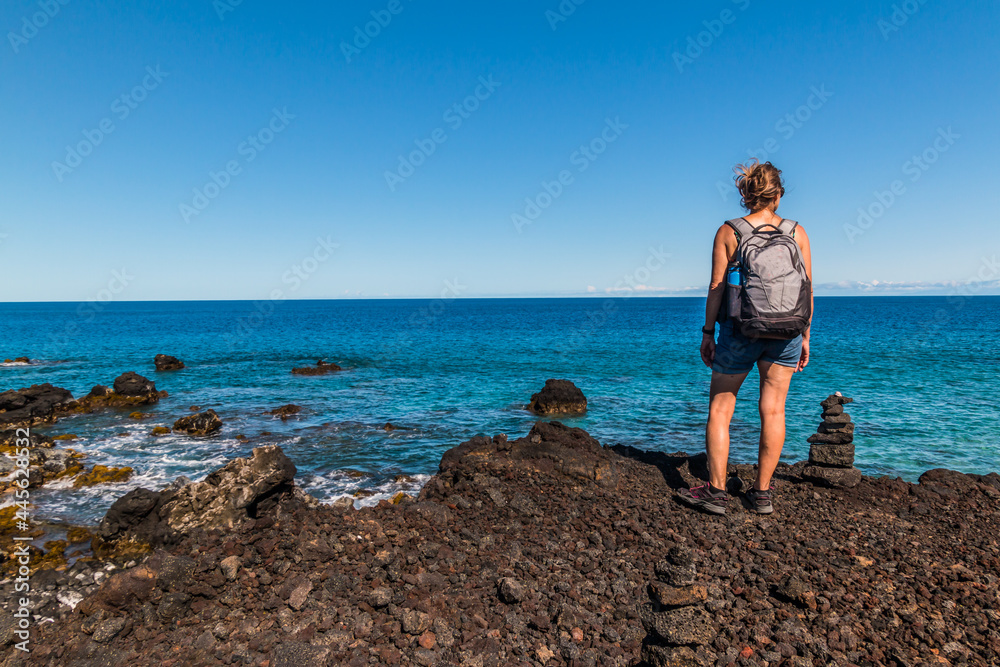 Female Hiker Overlooking Tide Pools and Exposed Lava Reef on Anaeho'omalu Bay, Hawaii Island, Hawaii, USA