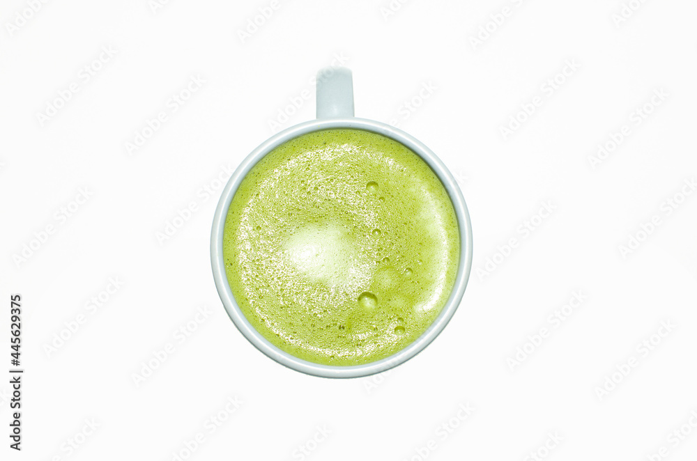 Matcha, green tea latte in a cup. white isolated background. Close up. Top view. Matcha, green tea latte in a cup. white isolated background. Close up. Top view.