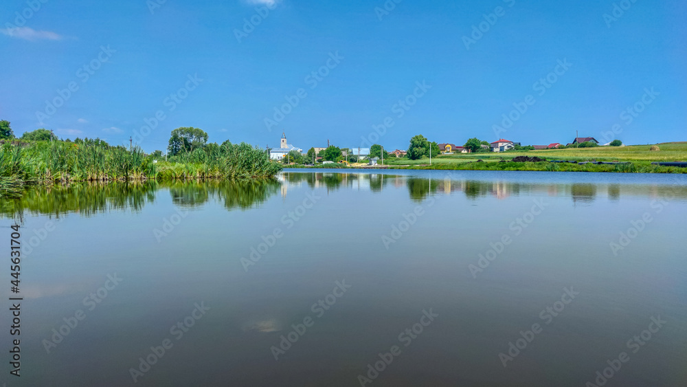 Fototapeta premium Landscape with a lake and clouds in the sky in the summer season