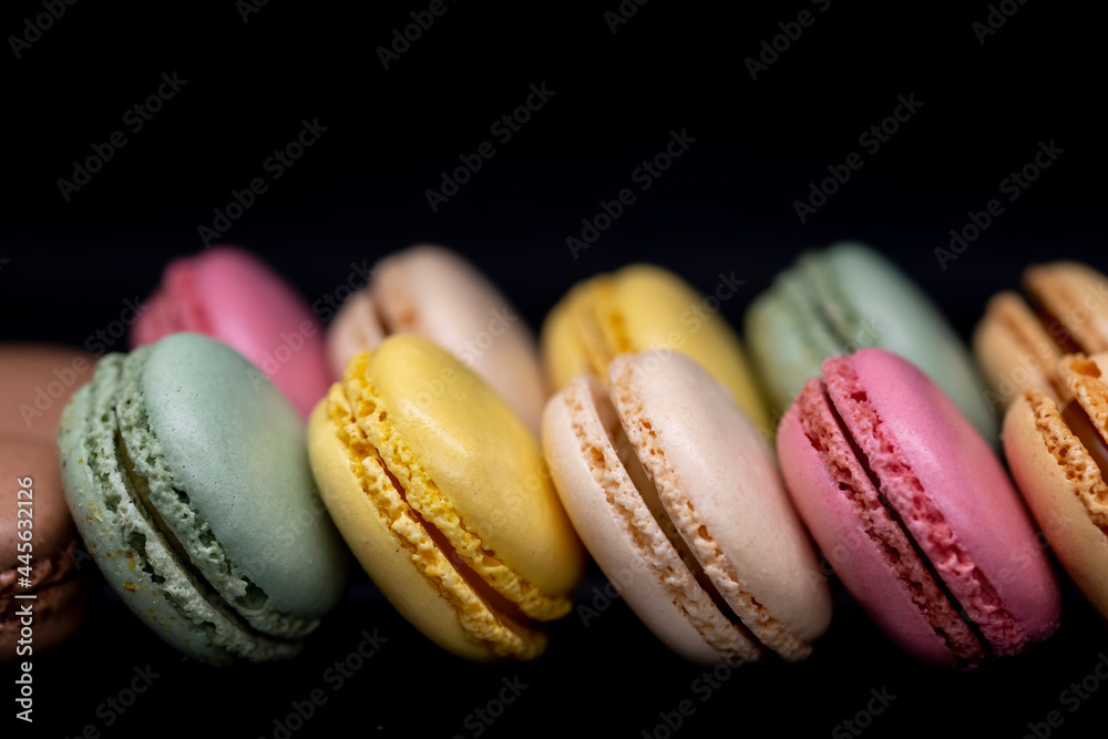 macaroons of different colors on a black background macaroons of different colors on a black background