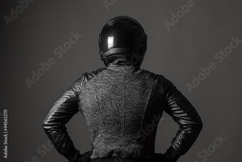 Motorbiker with a hands on his belt looks forward. Back view. © Dmitriy