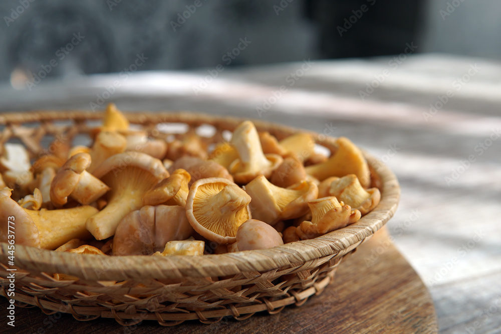 mushrooms chanterelles a small ginger in a basket a wicker bowl on the table mushrooms chanterelles a small ginger in a basket a wicker bowl on the table