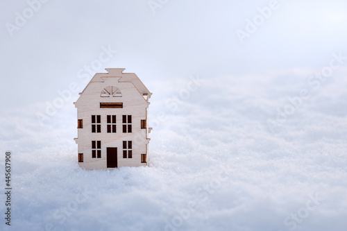 a wooden house stands in the snow in winter  cozy warm home for a family  insulation and heating in the winter season