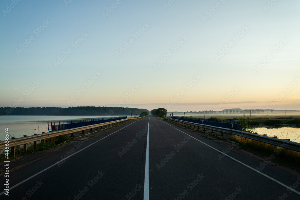 Fototapeta premium Calm empty asphalt road without cars at sunrise