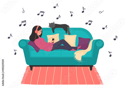 Listen to the music. Woman lays on sofa rests and listens to relax music. 
