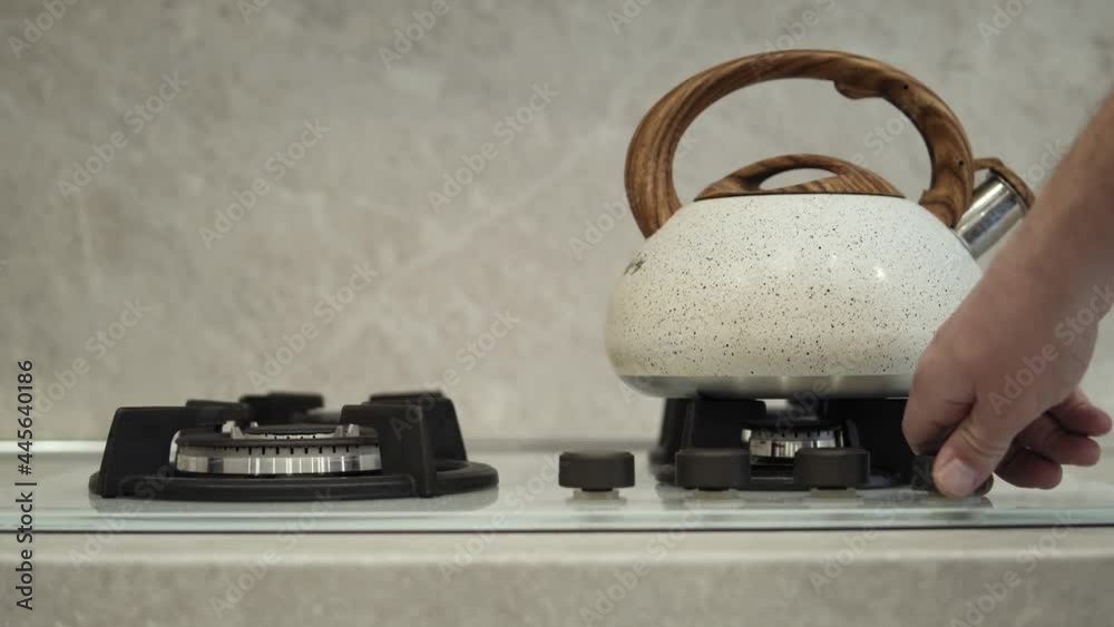 Vidéo Stock Closeup of a white kettle on a gas stove. Unrecognizable