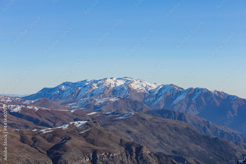 chain of mountains covered by snow and clouds in Santiago Chile chain of mountains covered by snow and clouds in Santiago Chile