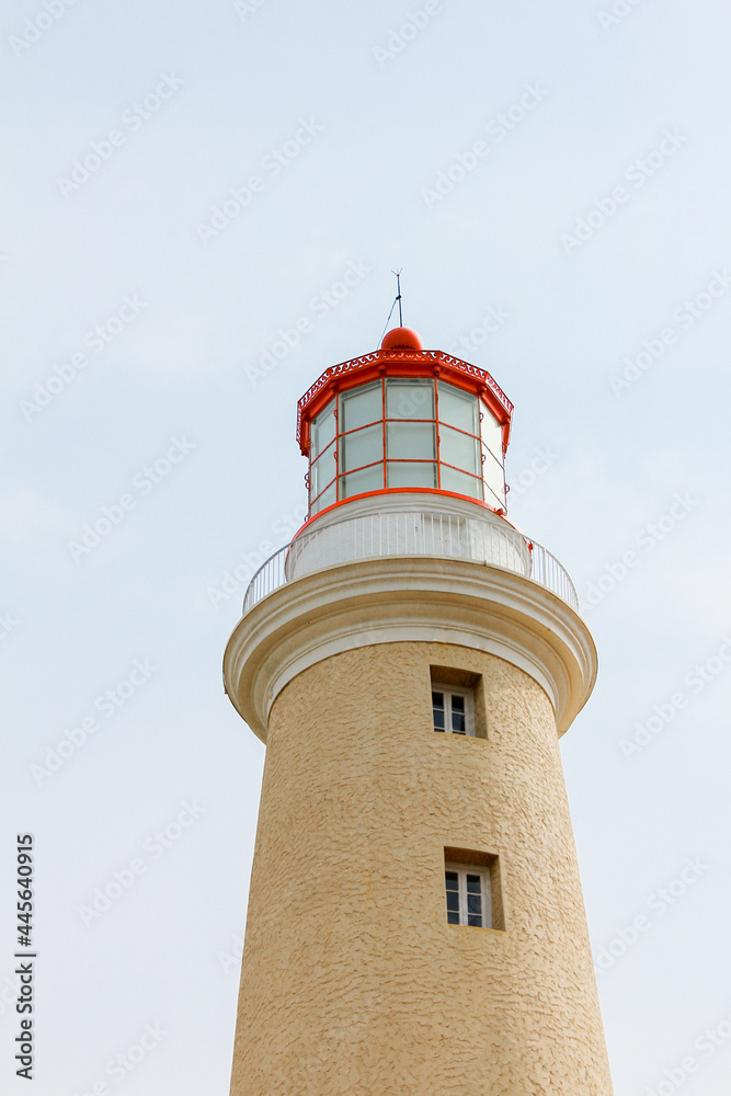 Red and yellow lighthouse on the coast of Atlantic Ocean in Punta del Este Uruguay
