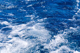 Abstract blue sea water with white wave for background. Adreatic sea, blue mediterranean sea. sea splash sailing boat trail on the water