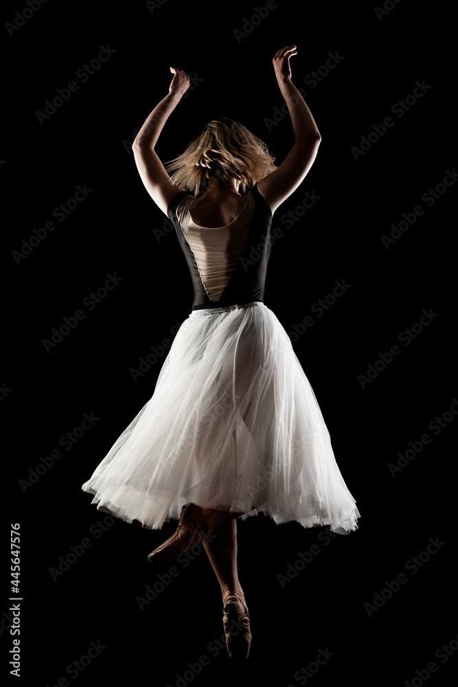 ballerina with a white dress and black top posing on black background ballerina with a white dress and black top posing on black background