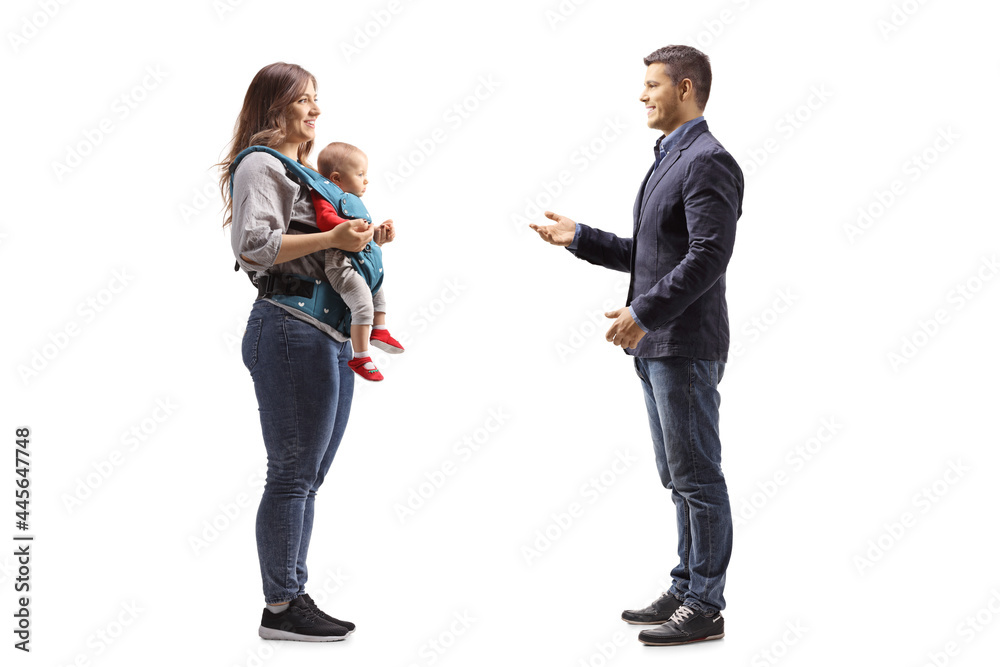 Full length profile shot of a man talking to a mother with a baby in a carrier Full length profile shot of a man talking to a mother with a baby in a carrier