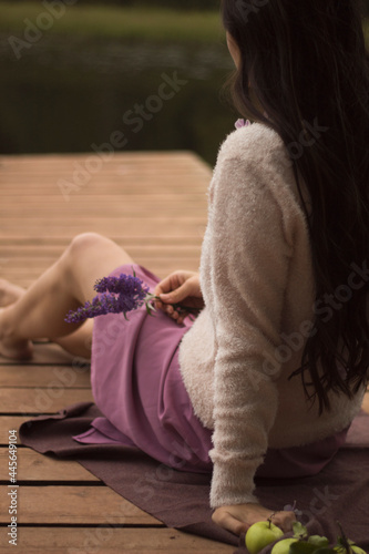a girl sitting by the water and enjoying the beauty of nature