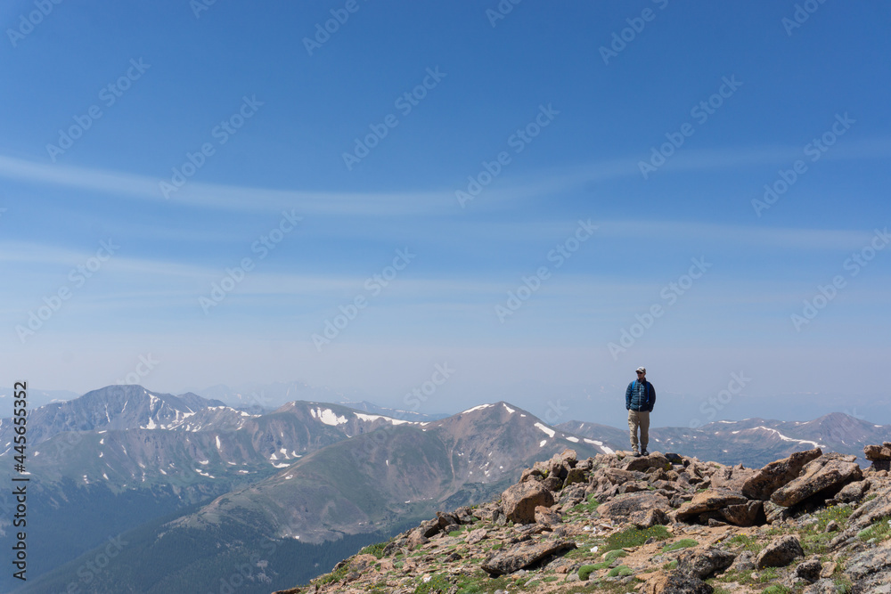 Backpacker looking out from peak of Mount Parnassus