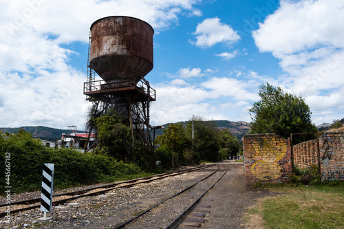 Train tracks that cross steep mountains and green trees in Colombia. photo