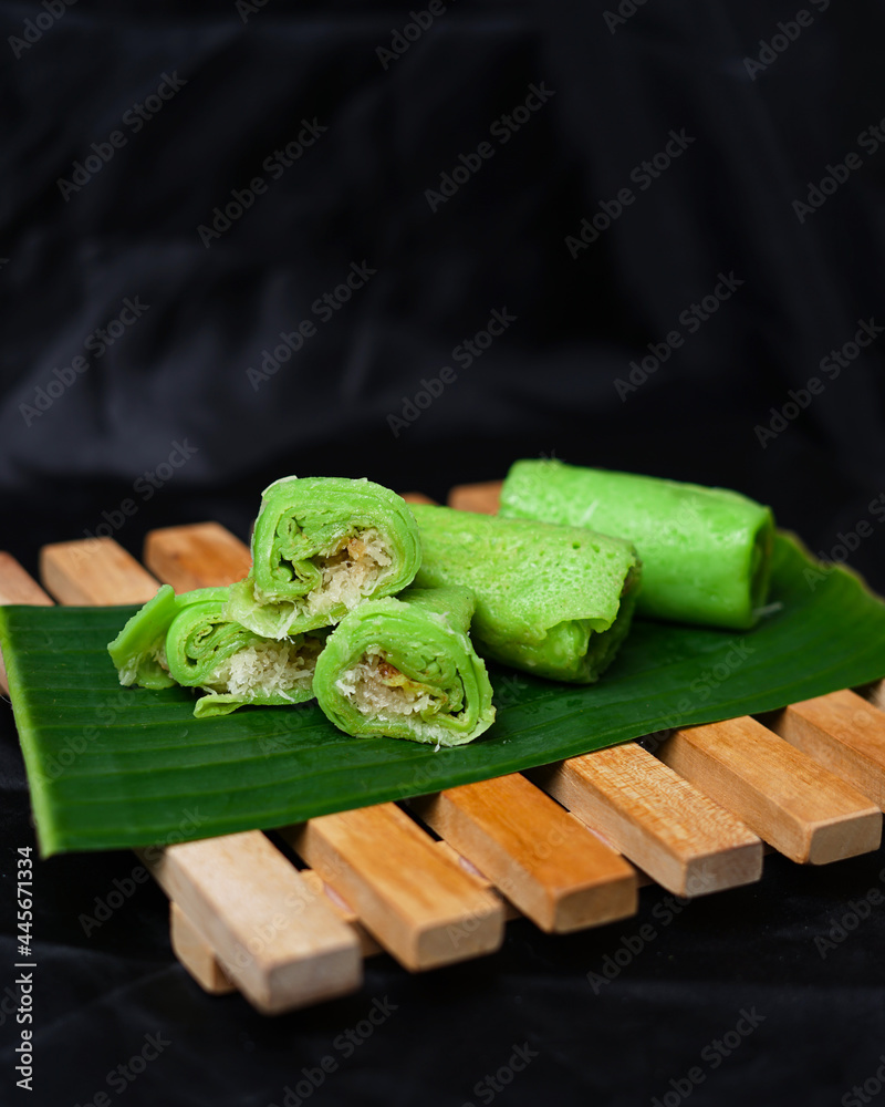 Pandan green pancake rolls on black background. Dadar Gulung is a