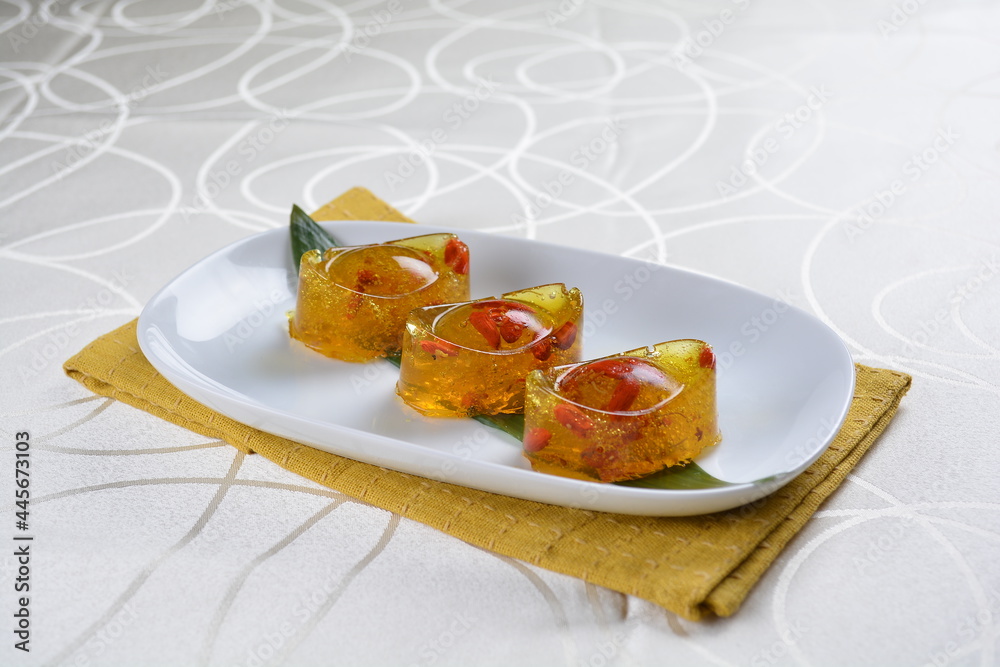 chinese dessert cold jelly with herb gui Hua flower yellow pudding in yuan bao money shape asian banquet halal menu chinese dessert cold jelly with herb gui Hua flower yellow pudding in yuan bao money shape asian banquet halal menu