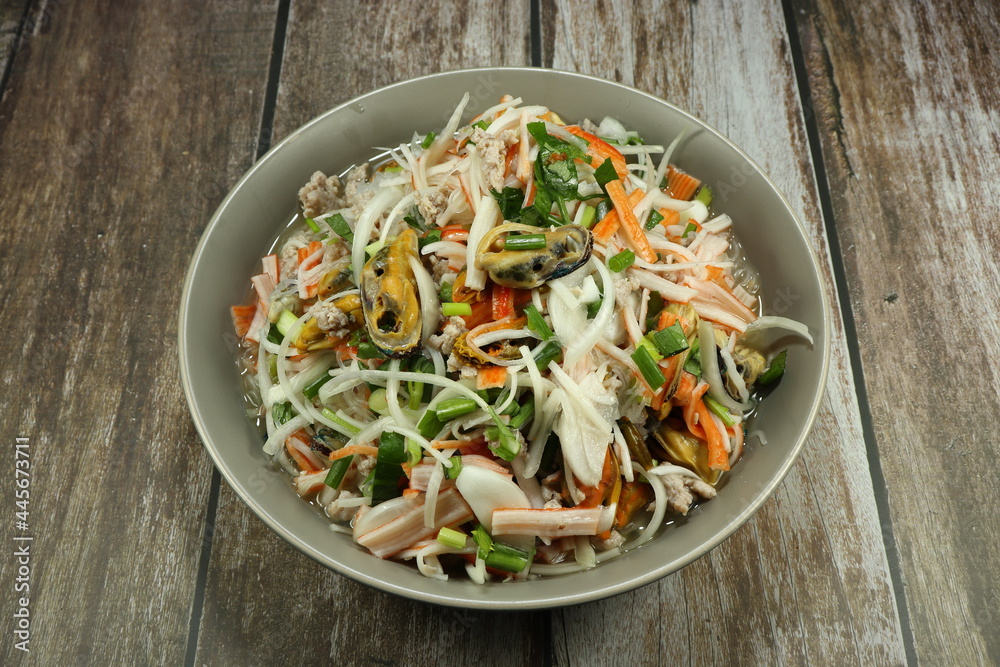 Traditional spicy mixed seafood salad serving on the plate. Famous appetizer menu in Asia restaurant. Traditional spicy mixed seafood salad serving on the plate. Famous appetizer menu in Asia restaurant.