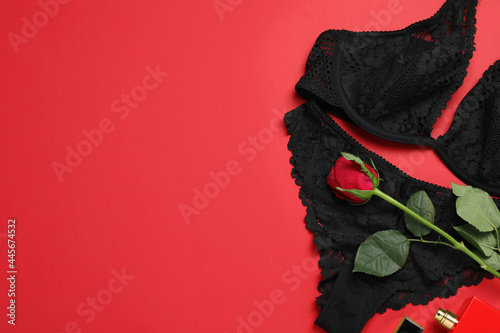 Flat lay composition with sexy lingerie on red background. Space for text © New Africa