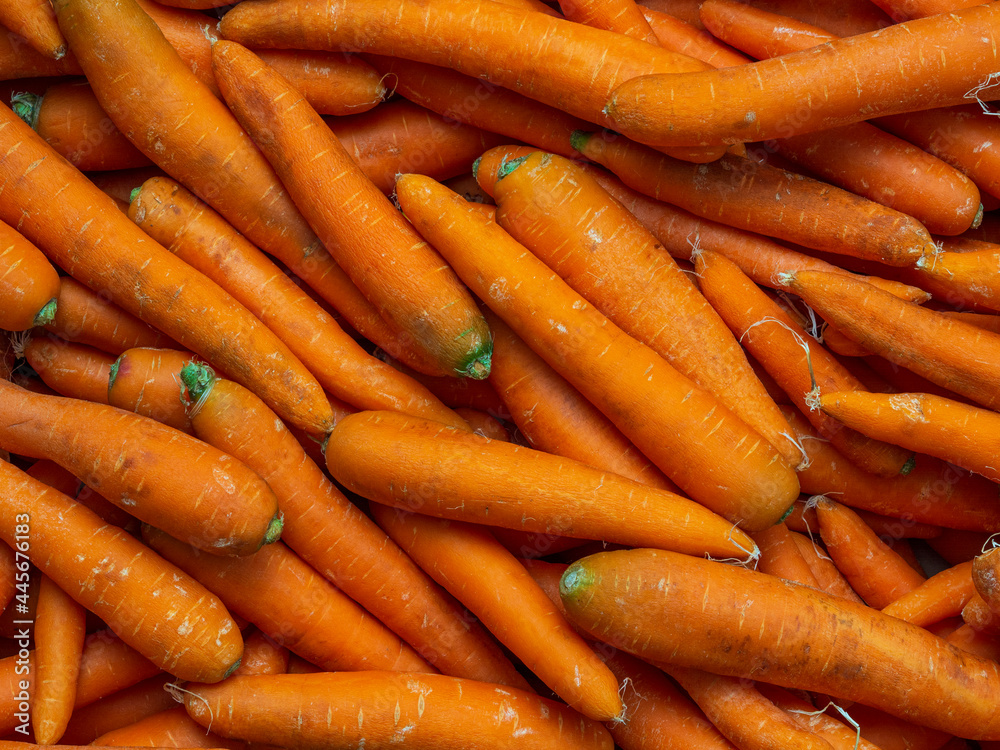 Background of washed orange carrots without green tops close-up in full screen. Autumn harvest concept, vegetables for sale Background of washed orange carrots without green tops close-up in full screen. Autumn harvest concept, vegetables for sale