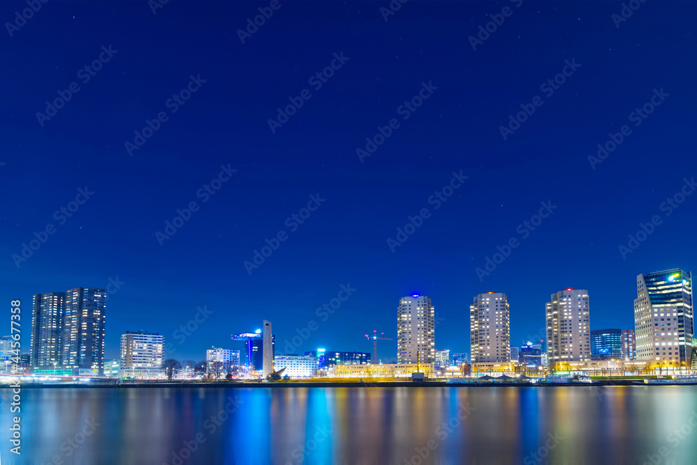 The river in Rotterdam in the Netherlands at night; a modern city, brightly lit The river in Rotterdam in the Netherlands at night; a modern city, brightly lit