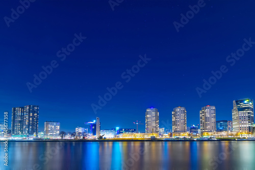 The river in Rotterdam in the Netherlands at night; a modern city, brightly lit