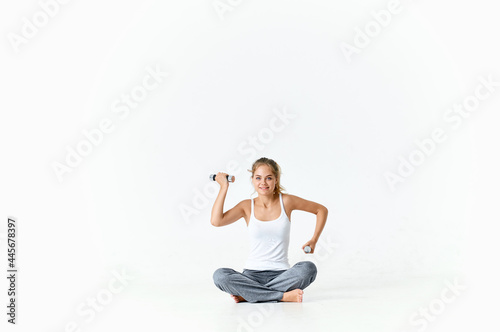 woman with green dumbbells in hands exercise workout gym fitness