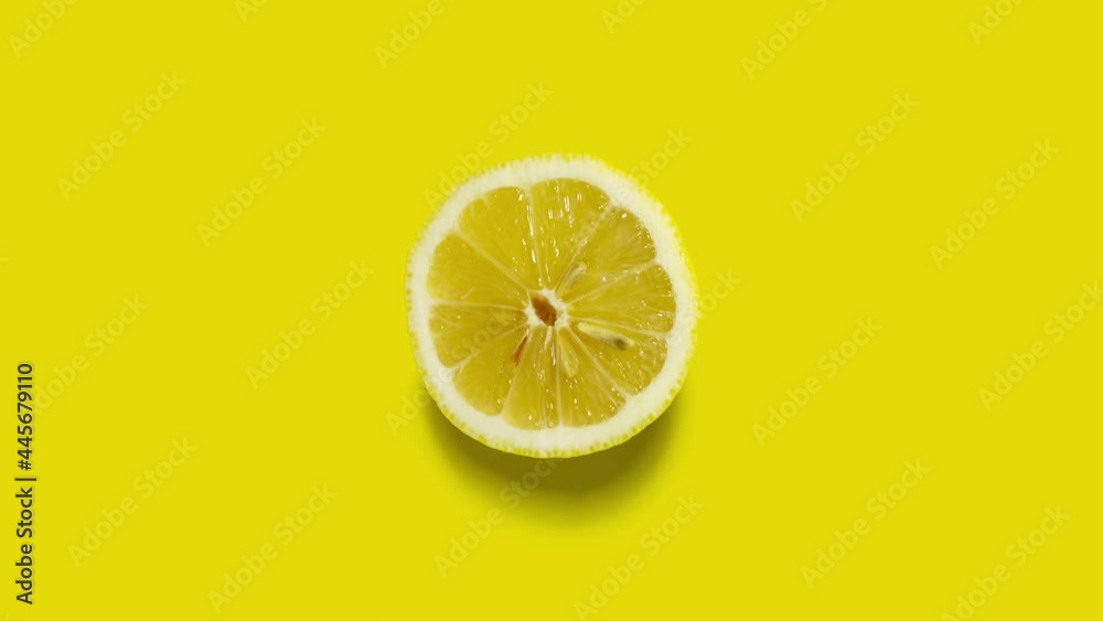Creative concept stop motion video footage movie gif. Food health diet cut raw lemon fruit on yellow background.