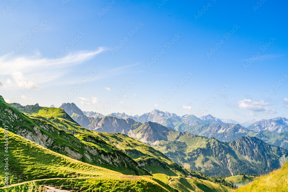 Fototapeta premium Aerial view of the beautiful scenery of Piz Por in the Alps in Switzerland under the blue sky and white clouds