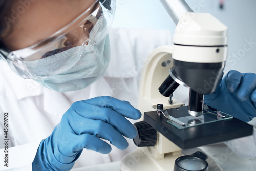 woman laboratory assistant microscope diagnostics research science