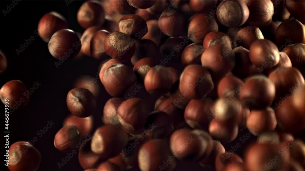 Super slow motion a bunch of hazelnuts takes off and falls. On a black background. Filmed on a high-speed camera at 1000 fps. Super slow motion a bunch of hazelnuts takes off and falls. On a black background. Filmed on a high-speed camera at 1000 fps.