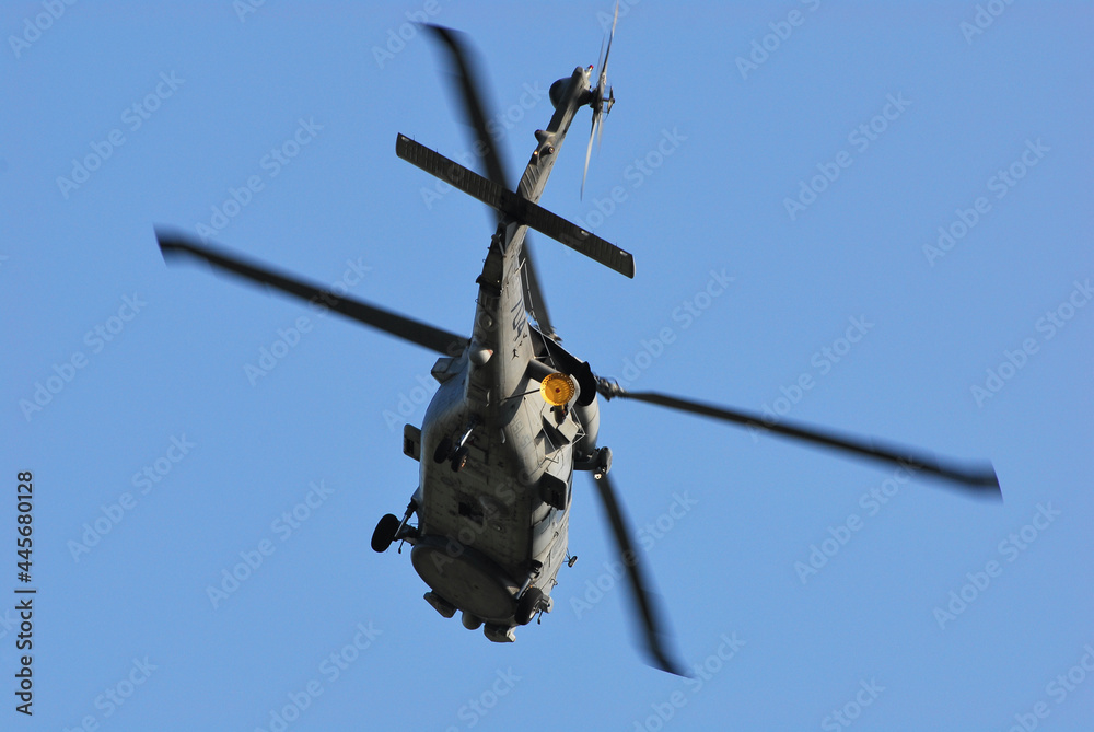 A military helicopter that passes over the sky. A military helicopter that passes over the sky.