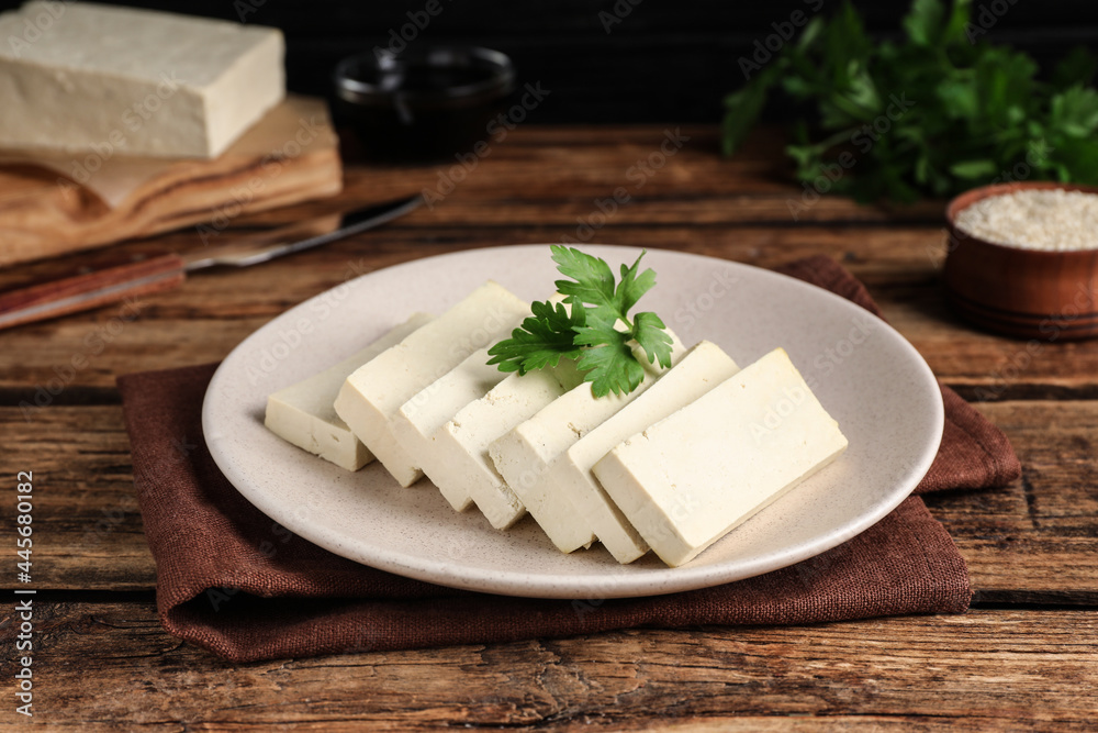 Delicious tofu with parsley on wooden table Delicious tofu with parsley on wooden table