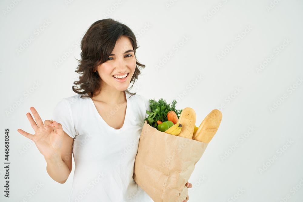 cute brunette in white t-shirt package with vegetables groceries supermarket cute brunette in white t-shirt package with vegetables groceries supermarket