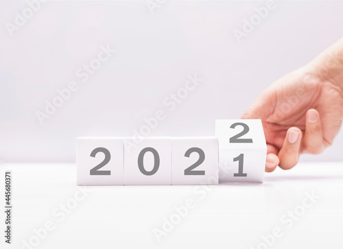 arranging white block with 2021 to 2022, happy new year anniversary of world